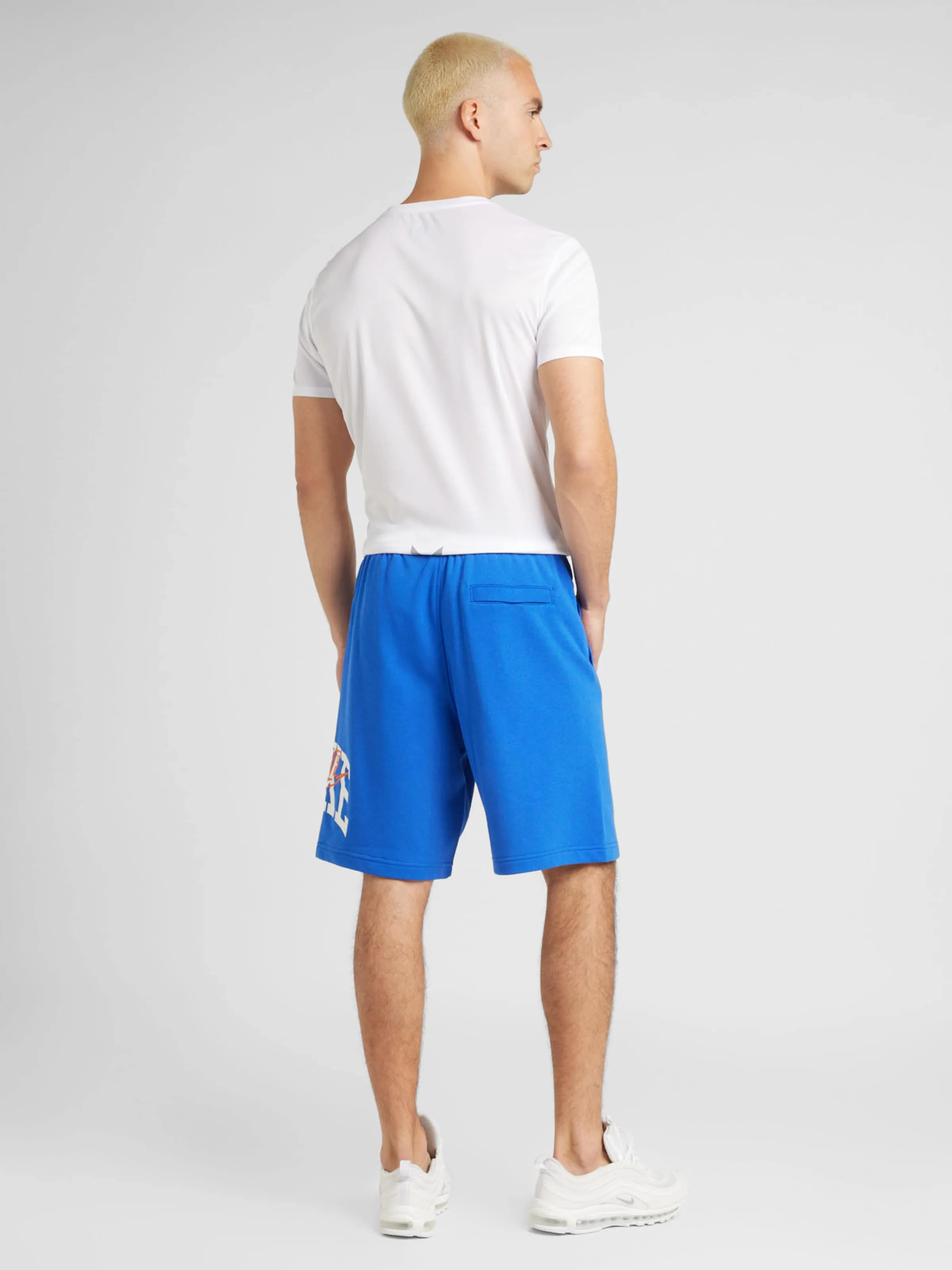Loosefit Pantalón 'CLUB' Nike Sportswear en Azul Real